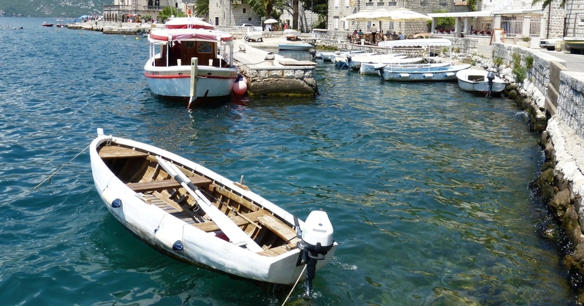 Boats moored along the stone waterfront of Perast on the Bay of Kotor